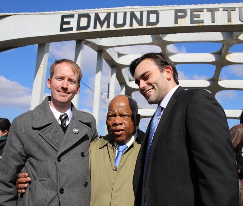 Rep. John Lewis stands with co-author Andrew Aydin, right, and illustrator Nate Powell on the Edmund Pettus Bridge. Aydin persuaded the civil rights pioneer to write a comic book about his experiences. It turned into a trilogy, with the final installment, "Run," coming out after Lewis' death.