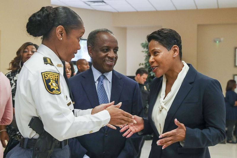 DeKalb County CEO Michael Thurmond (center) looks on as newly appointed DeKalb Police Chief Mirtha Ramos (right) introduces herself to DeKalb Sheriff’s Office Chief Deputy Melody Maddox (left) before a press conference at the Manuel J. Maloof Auditorium in Decatur on October 7, 2019.  (Alyssa Pointer/Atlanta Journal Constitution)