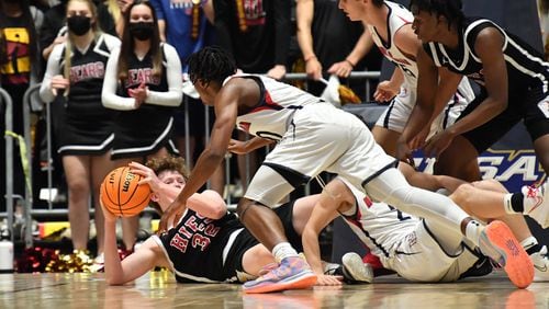 March 10, 2021 Macon - Holy Innocents' Walker Wolf (32) holds onto a loose ball as he falls to the court during the 2021 GHSA State Basketball Class A Private Championship game at the Macon Centreplex in Macon on Wednesday, March 10, 2021. Mt. Pisgah won 43-41 over Holy Innocents. (Hyosub Shin / Hyosub.Shin@ajc.com)