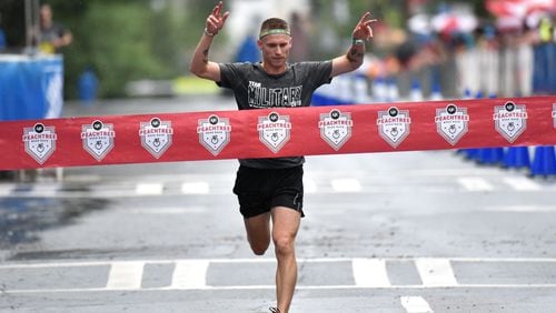 David Seymour with Team Army wins Kilometer Kids Charity Chase during the AJC Peachtree Road Race on Saturday, July 4, 2015. Kilometer Kids Charity Chase will feature six teams: Team Air Force, Team Army, Team Coast Guard, Team Marine Corps, Team National Guard and Team Navy. HYOSUB SHIN / HSHIN@AJC.COM
