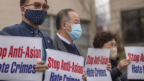 Members of the the Atlanta Korean-American Committee against Asian Hate Crimes hold signs during a a vigil for the victims of the spa shootings outside of the Gold Spa in Atlanta on March 19, 2021. The committee consists of Korean-American community members, business leaders and religious leaders.  (Alyssa Pointer / Alyssa.Pointer@ajc.com)