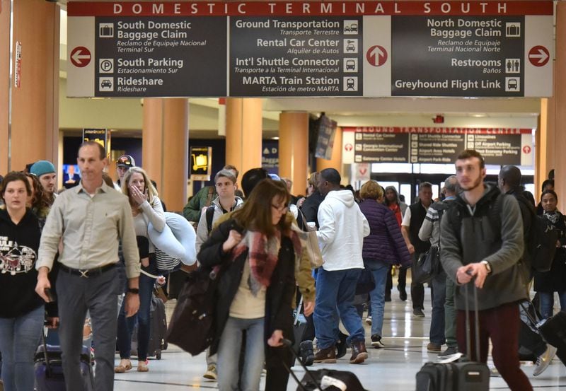 Atlanta - Travelers head toward security lines and baggage claim at Hartsfield-Jackson International Airport on Wednesday, November 21, 2018. HYOSUB SHIN / HSHIN@AJC.COM