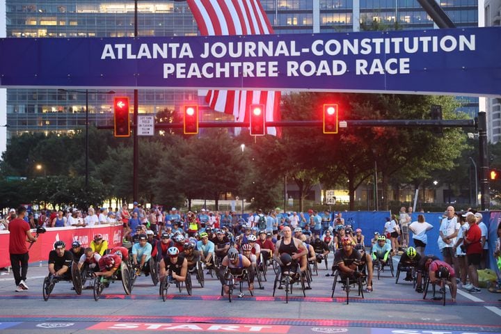 Wheelchair racers prepare for the start of the 54th running of The Atlanta Journal-Constitution Peachtree Road Race in Atlanta on Tuesday, July 4, 2023.   (Arvin Temkar / Arvin.Temkar@ajc.com)