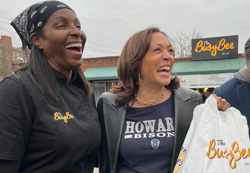 Busy Bee owner Tracy Gates (left) and Vice President Kamala Harris share a laugh outside the restaurant during a December visit. (Tia Mitchell/tia.mitchell@ajc.com)