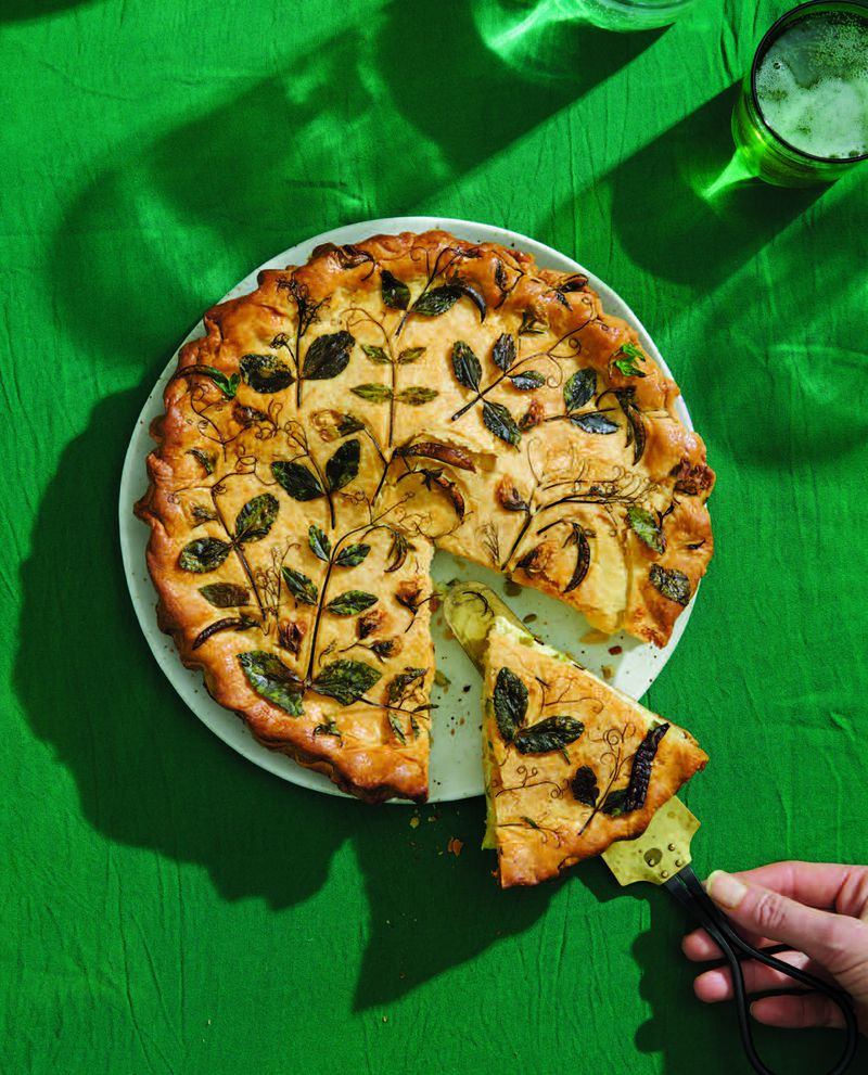 Pea Tendril Pressed Pie is essentially a double-crust quiche decorated with pea tendrils, herbs and edible flowers. (Courtesy of "Eat Your Flowers" / William Morrow)