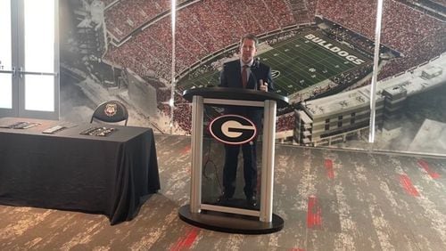 Georgia Gov. Brian Kemp (R-Athens) speaks to a small gathering in the Georgia Bulldogs' recruiting lounge at Sanford Stadium before signing into law House Bill 617, which will give college athletes the right to make money off their name, image or likeness. (Photo by Greg Bluestein/AJC)