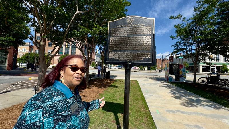 Librarian Muriel Jackson in front of one of downtown Macon's new Black history markers, which are part of a self-guided tour along the city's Black Heritage Trail.