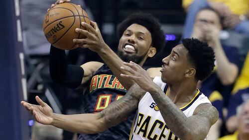 Atlanta Hawks’ DeAndre’ Bembry and Indiana Pacers’ Jeff Teague vie for a rebound during the first half of an NBA basketball game Wednesday, April 12, 2017, in Indianapolis. (AP Photo/Darron Cummings)