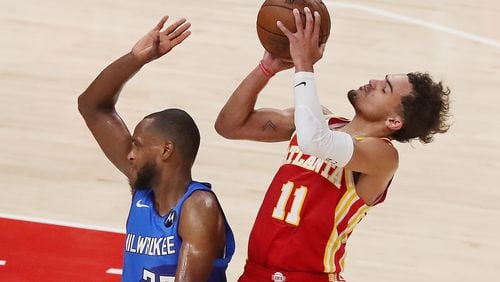 Hawks guard Trae Young draws a foul from Milwaukee Bucks forward Khris Middleton during the third quarter of Game 3 of the Eastern Conference finals Sunday, June 27, 2021, at State Farm Arena in Atlanta. (Curtis Compton / Curtis.Compton@ajc.com)