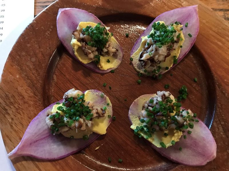 An evening at Red Barn means celebrating the bounty of the						moment. A recent visit included this starter of purple daikon						radish topped with cashew cream, shiitakes and chives. LIGAYA						FIGUERAS / LFIGUERAS@AJC.COM