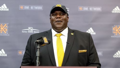 Milton Overton models his new wardrobe during his introductory press conference as Kennesaw State's incoming athletic director. (Kyle Hess/Kennesaw State Athletics)