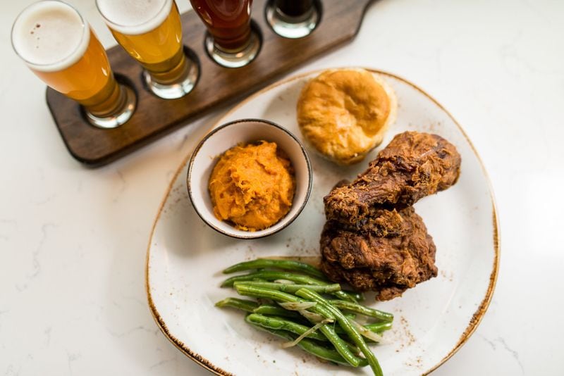  Southern fried chicken with molasses biscuit, braised green beans, and sweet potato mash and a local beer flight at Chicken + Beer. / Photo credit- Mia Yakel.