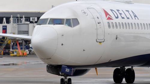 Delta plane approaches gate at Hartsfield-Jackson. HYOSUB SHIN / HSHIN@AJC.COM