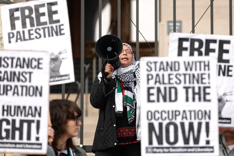 Jawahir Kamal, a member of the Party for Socialism and Liberation, speaks during a protest Monday outside the Capitol opposing Israel's military attacks in the Gaza Strip in its war against Hamas. (Natrice Miller/ Natrice.miller@ajc.com)