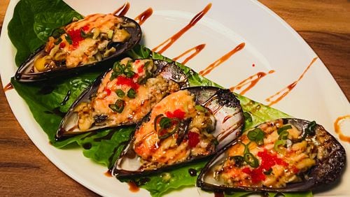 Baked green mussels at Mai Kitchen were a bit like oysters Rockefeller, only with Asian flavors. Henri Hollis/henri.hollis@ajc.com