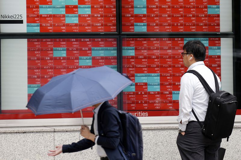 A person looks at an electronic stock board showing Japan's stock prices at a securities firm Tuesday, April 30, 2024, in Tokyo. Asian shares mostly rose Tuesday, as investors kept their eyes on potentially market-moving reports expected later this week. (AP Photo/Eugene Hoshiko)