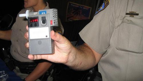 A police officer holds up a Breathalyzer device. New technology, similar to a Breathalyzer, from an Israeli research team makes it possible to analyze a person’s breath to diagnose 17 different diseases, including cancer.