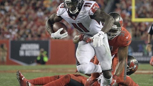 Atlanta Falcons wide receiver Julio Jones (11) slips a tackle by Tampa Bay Buccaneers outside linebacker Daryl Smith (51) during the third quarter of an NFL football game Thursday, Nov. 3, 2016, in Tampa, Fla. (AP Photo/Phelan Ebenhack)