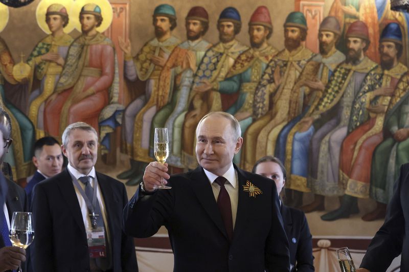 Russian President Vladimir Putin, front, toasts as he attends an official reception, to mark 79th anniversary of the end of World War II, in the Palace of the Facets at the Kremlin in Moscow, Russia, Thursday, May 9, 2024. Russia is wrapping itself in patriotic pageantry for Victory Day, a celebration of its defeat of Nazi Germany in World War II that President Vladimir Putin has turned into a pillar of his nearly quarter-century in power and a justification of his military action in Ukraine. (Mikhail Metzel, Sputnik, Kremlin Pool Photo via AP)