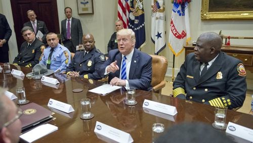 President Donald Trump meets Thursday at the White House with the first responders from the I-85 bridge collapse. (Photo by Ron Sachs - Pool/Getty Images)