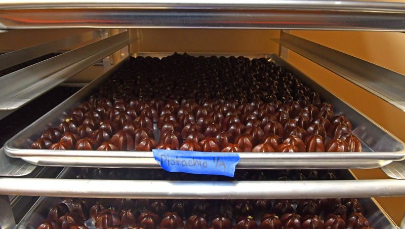 Chocolates await packaging in the cold storage area which must have a controlled temperature and humidity prior to the chocolate's packaging. Photo from a preview tour of Bitzel's Chocolate factory on Tuesday, Jan. 9, 2024, a new chocolate shop opening in Suwanee, Ga. in January 2024. (CHRIS HUNT FOR THE ATLANTA JOURNAL-CONSTITUTION)