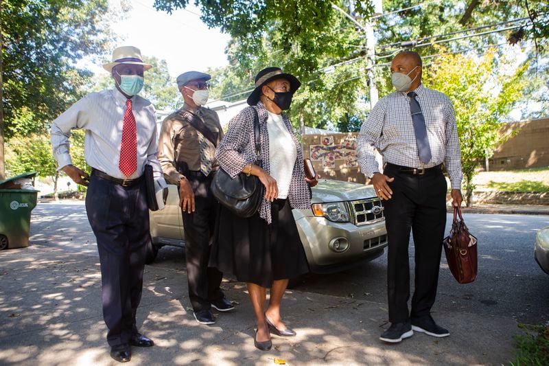 (Left to right) Walter Delaney, Sam Hall, Gwen Lawson and Herb Joseph, Jehovah's Witnesses, go door-to-door . They still take precautions like wearing masks. CHRISTINA MATACOTTA FOR THE ATLANTA JOURNAL-CONSTITUTION.