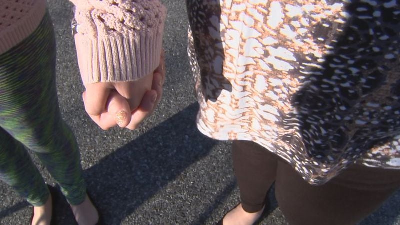 A Blairsville woman holds hands with her 20-year-old daughter, who told police that a traveling evangelist raped and molested her in 2012. CHANNEL 2 ACTION NEWS
