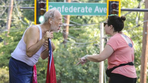 Confederate Flag runner, Alan Keck (left) debates Grant Park resident, Katie Kurumada (right) about the petition to change the name of Confederate Avenue on Tuesday, Aug. 15, 2017 on Boulevard. The Atlanta City Council will consider a proposal pushed by residents to rename the street. JOHN SPINK/JSPINK@AJC.COM