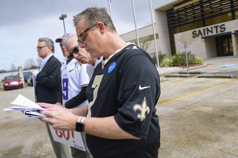 Members of SNAP,  including John Gianoli, left, John Anderson, Richard Windmann and Kevin Bourgeois, read a news release from the New Orleans Saints, who deny involvement in trying to cover up a scandal.