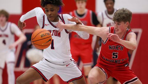 Milton forward Anthony Gause (1) steals the ball away from North Gwinnett guard Charlie Gallagher (5) during their first round of the boys’ Class 7A playoffs at Milton High School, Wednesday, February 21, 2024, in Milton, Ga. Milton won 67-54. (Jason Getz / jason.getz@ajc.com)
