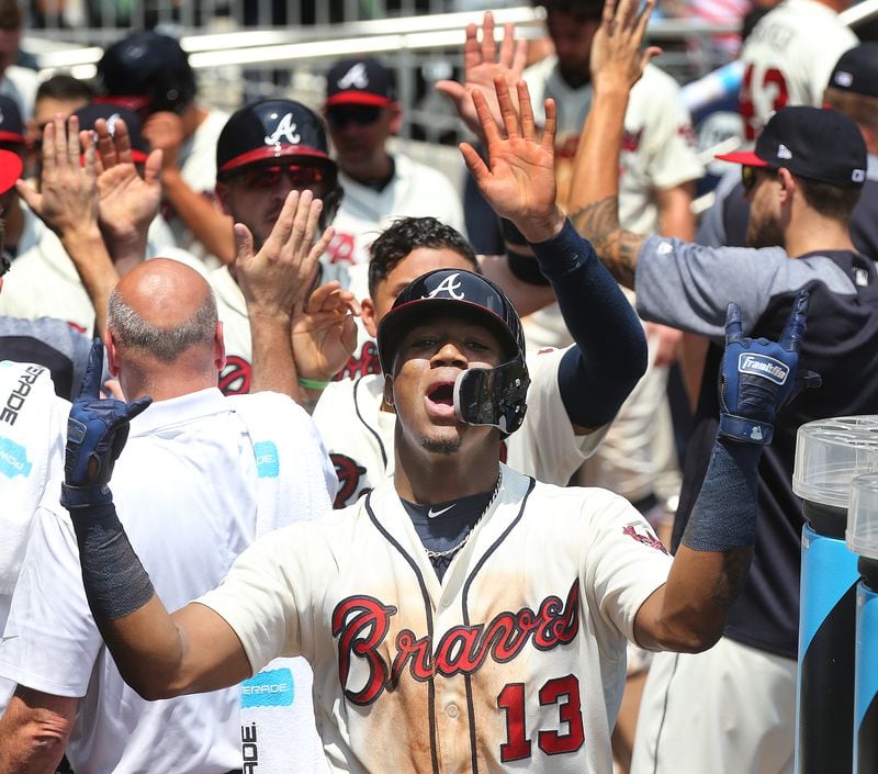 Braves’ Ronald Acuna Jr. reacts in the dugout after hitting a 2-run homer to take a 4-2 lead over the Milwaukee Brewers during the second inning in a MLB baseball game on Sunday, August 12, 2018, in Atlanta.  Curtis Compton/ccompton@ajc.com