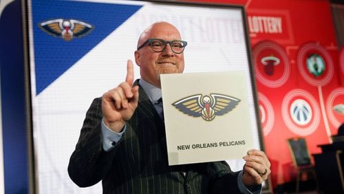 David Griffin, executive vice president of basketball operations for the New Orleans Pelicans, holds up the placard after his team won the No. 1 pick.