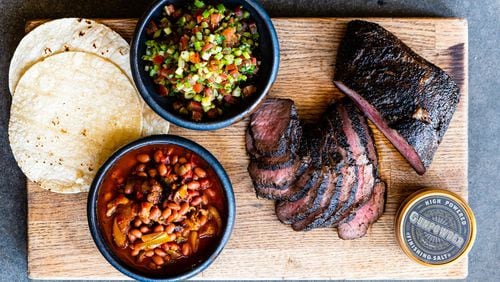 Kevin Gillespie’s Santa Maria BBQ with Gunpowder Finishing Salt, accompanied by Santa Maria-Style Salsa (upper center) and pinquito beans (lower left). CONTRIBUTED BY HENRI HOLLIS