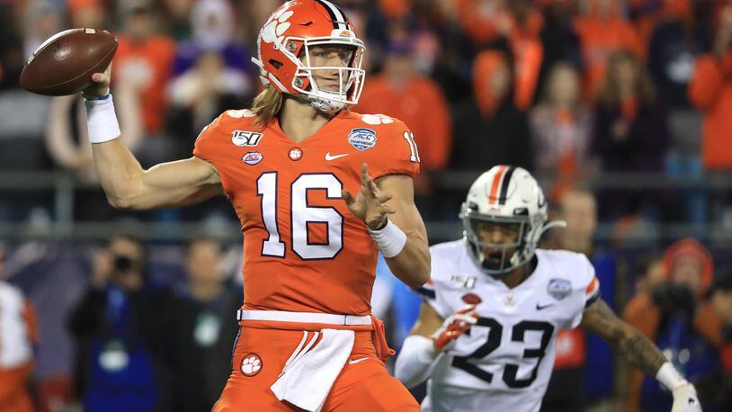 Trevor Lawrence #16 of the Clemson Tigers drops back to pass against the Virginia Cavaliers during the ACC Football Championship game at Bank of America Stadium on December 07, 2019 in Charlotte, North Carolina. (Photo by Streeter Lecka/Getty Images)