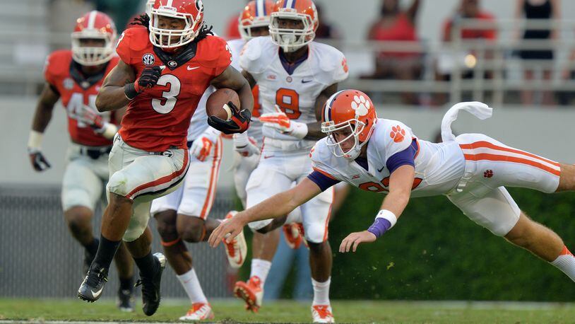 The last time Georgia and Clemson played in football, running back Todd Gurley rushed for 198 yards and three touchdowns and returned a kickoff 100 yards for another score in a 45-21 win by the Bulldogs on Aug. 30, 2014, in Sanford Stadium. The teams will meet for the first time since then in the Duke's Mayo Classic game in Charlotte, N.C., on Sept. 4, 2021.  (AJC file photo)