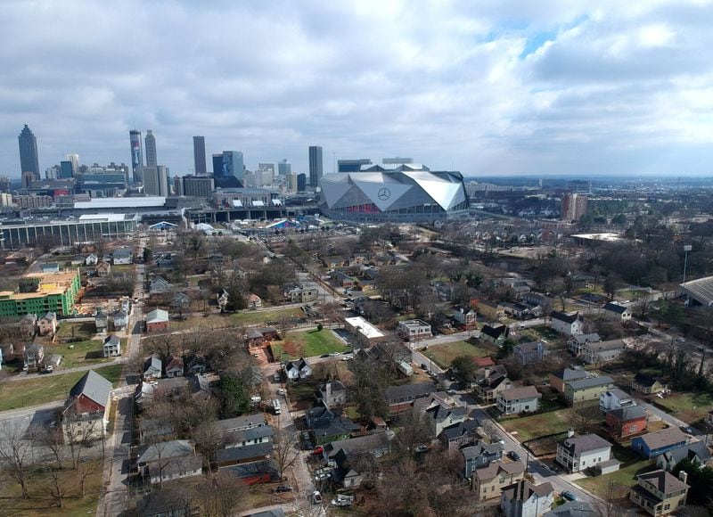 Aerial view of neighborhoods west of downtown Atlanta in the foreground and Mercedes-Benz Stadium in the background on Thursday, January 24, 2019. HYOSUB SHIN / HSHIN@AJC.COM