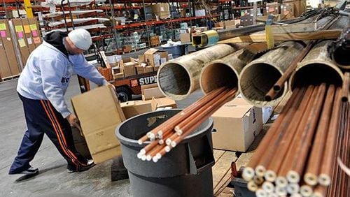 Worker at a HD Supply distribution center. The Atlanta-based company, once a part of Home Depot, has a deal to merge once again back into the home improvement giant.