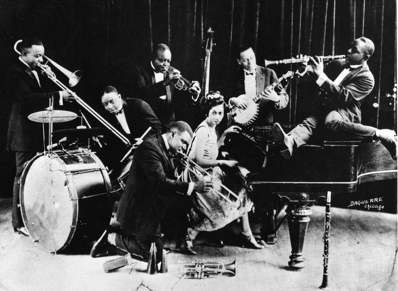 New Orleans horn legends Joe “King” Oliver (standing, center) and Louis Armstrong (kneeling) will be celebrated at a Cityfolk jazz concert this Saturday at Gilly’s.