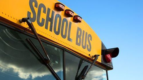 Students and a bus driver were hurt Monday when a bus overturned on a sharp curve.