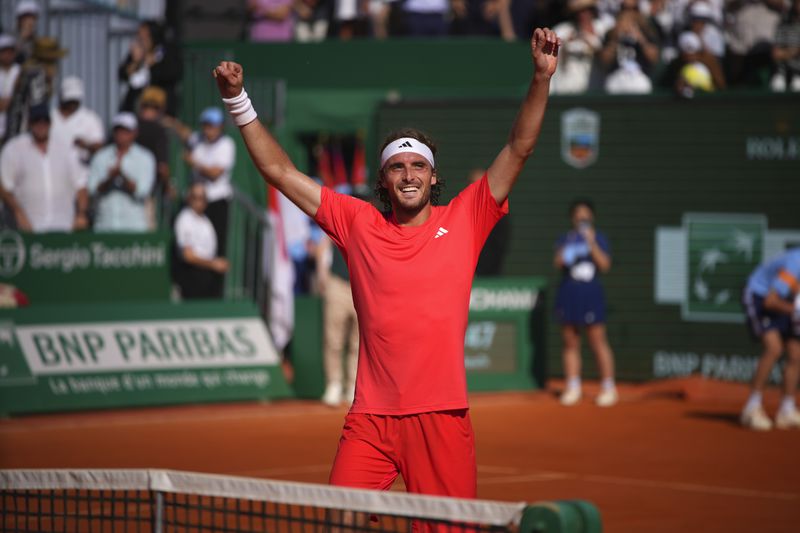 Stefanos Tsitsipas of Greece celebrates after winning the 2nd set against Casper Ruud of Norway to win the Monte Carlo Tennis Masters final match 6-1, 6-4 in Monaco, Sunday, April 14, 2024. (AP Photo/Daniel Cole)
