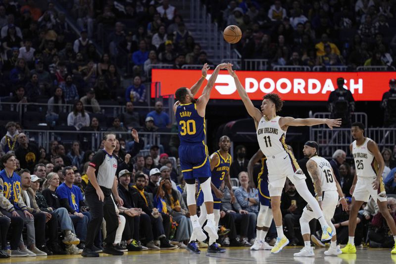 Golden State Warriors guard Stephen Curry (30) shoots a 3-point basket over New Orleans Pelicans guard Dyson Daniels (11) during the second half of an NBA basketball game Friday, April 12, 2024, in San Francisco. (AP Photo/Godofredo A. Vásquez)