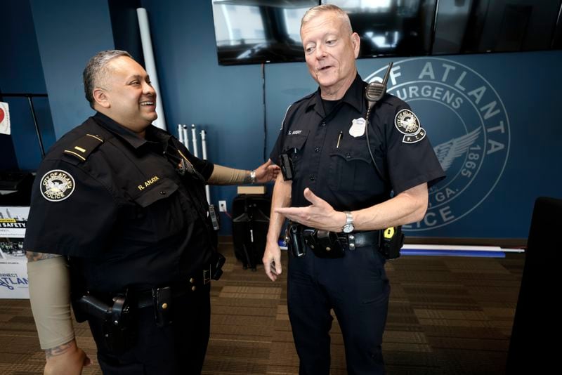 Officer Steve Avery speaks with Lt. Renato Anaya (left). Atlanta police and the community have recognized Anaya for his service after he helped a woman to deliver a baby on June 25 at a gas station. Miguel Martinez / Miguel.martinezjimenez@ajc.com
