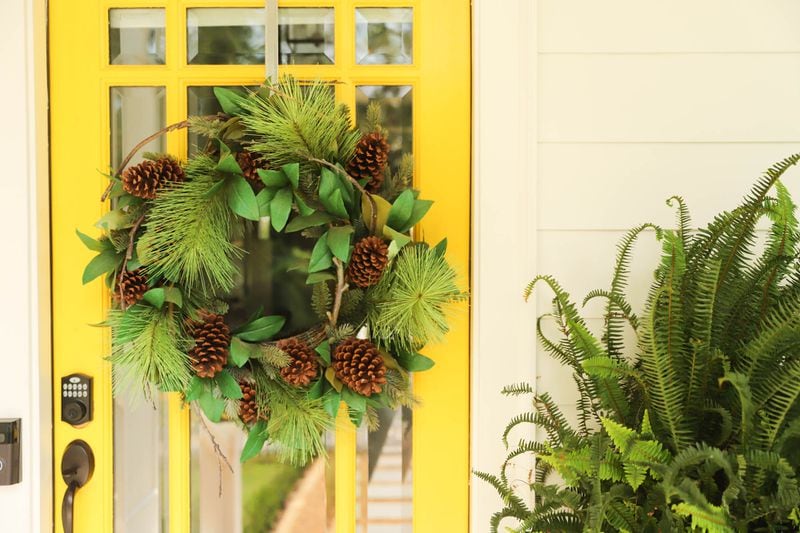 Wreaths are not just for Christmas. Adding pine cones to a wreath can give it a rustic look. Reynolds Rogers/FOR THE AJC