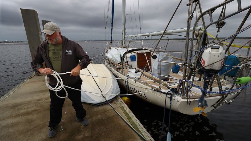 Dana Burchatz, 57, secures his 34-foot Morgan sailboat he recently purchased to the dock at Lang’s Marina hoping for the best while preparing for Hurricane Ian on Wednesday, Sept. 28, 2022, in St. Mary’s. Curtis Compton / Curtis Compton@ajc.com