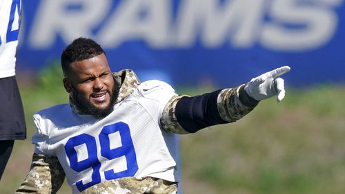 Los Angeles Rams defensive end Aaron Donald gesture prior to practice for an NFL Super Bowl football game Wednesday, Feb. 9, 2022, in Thousand Oaks, Calif. The Rams are scheduled to play the Cincinnati Bengals in the Super Bowl on Sunday. (AP Photo/Mark J. Terrill)