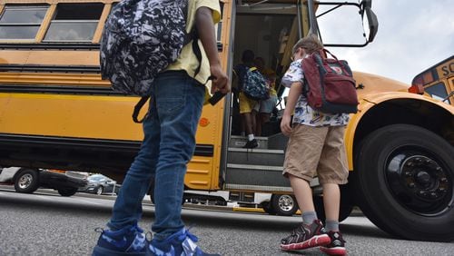 Students board a bus at Burnette Elementary School in Suwanee on Tuesday, August 13, 2019. (Hyosub Shin / Hyosub.Shin@ajc.com)