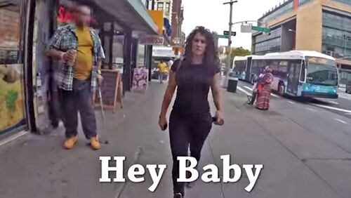 Screen grab from the Rob Bliss Creative Hollaback! video that depicts a woman walking in Manhattan, being harassed by male bystanders.
