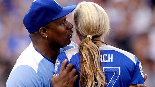 Former NFL and baseball star Bo Jackson whispers into the ear of Jennie Finch, former United States National Softball team pitcher, during the All-Star Legends &amp; Celebrity Softball Game at Kauffman Stadium in Kansas City, Mo., on July 8, 2012. (David Eulitt/Kansas City Star/TNS)
