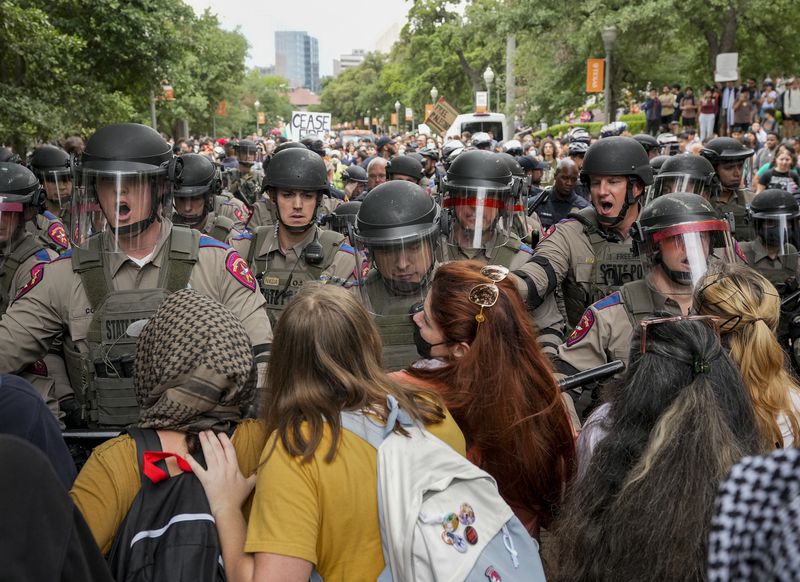 Texas state troopers in riot gear try to beak up a pro-Palestinian protest at the University of Texas, Wednesday, April 24, 2024, in Austin, Texas. (Jay Janner/Austin American-Statesman via AP)