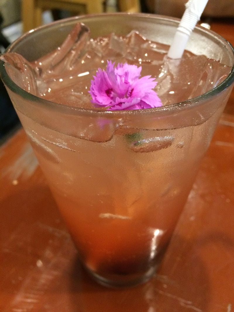 The fresh cherry-rosemary soda at Petit Chou is delicious and garnished with a tiny edible carnation. CONTRIBUTED BY WENDELL BROCK